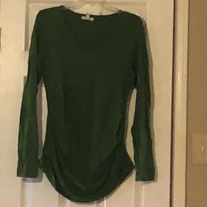 Maternity top with cinched sides.